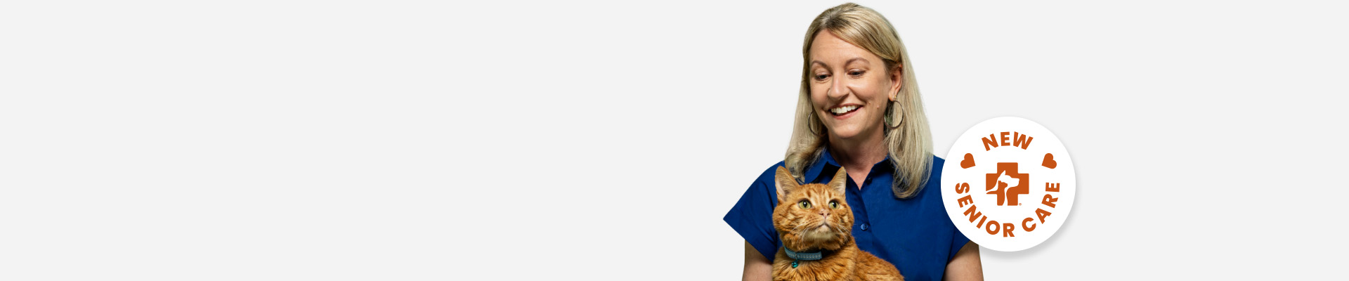 Loralee Stapleton, Director of Client Marketing, holding her orange cat, Zeus