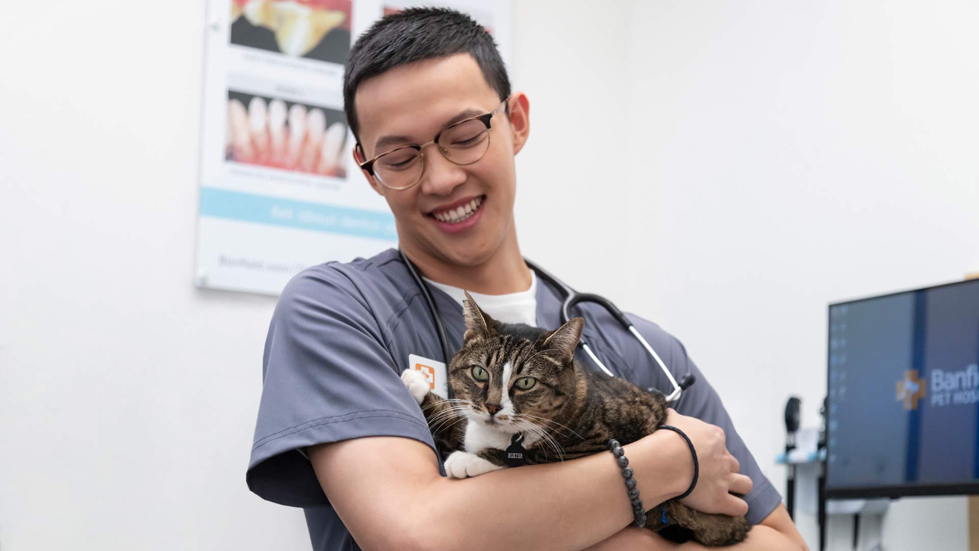 Vet assistant Joseph Slater holds a cat.