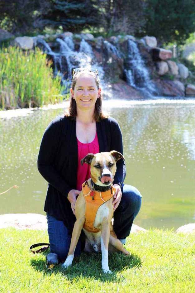 A young female dog owner and her dog